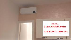 a room with a air conditioner and a sign on the wall at Palau Fonte Vecchia Apartment in Palau +17 photos