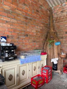 a brick wall with a counter with glasses on it at A casa do Rio - The River House in Arzúa