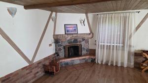 a living room with a brick fireplace in a house at Villa Oši in Roja
