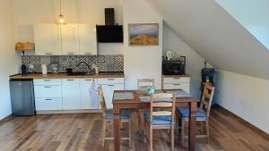 a kitchen and dining room with a table and chairs at Smerekowa Ostoja in Smerek