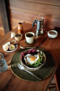 a wooden table with a plate with an egg and salad at The Stables in St Helens +14 photos