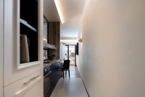 a kitchen with white cabinets and a dining room at Sea Path III Chania city Center luxury Suites in Chania