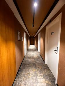a hallway with a long corridor with doors at MM Boutique Hotel in Burgas
