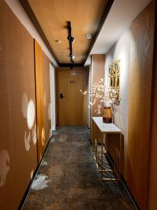 a hallway with a door and a table in a room at MM Boutique Hotel in Burgas