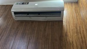 a printer is sitting on a wooden floor at Hotel J&B in Zirakpur