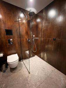 a bathroom with a toilet and a glass shower at MM Boutique Hotel in Burgas