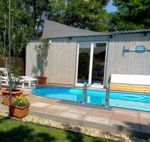 a swimming pool in a building with a tent at Idill Cottage Vendégház in Tiszafüred