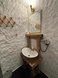 a bathroom with a wooden sink and a mirror at Bum Alaçatı in Çeşme