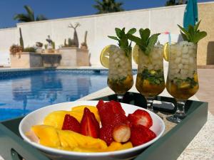 a bowl of fruit on a table near a pool at Maikran Premium Fantastic Family Villa with Pool in San Fulgencio