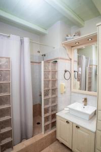 a bathroom with a sink and a shower at Villa Ostria in Koufonisia +68 photos