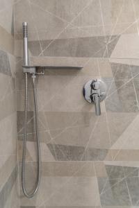 a shower with a shower head in a bathroom at Apartment Sole e Luna - Fronte Mare in Nettuno +59 photos