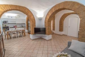 a living room with arches and a flat screen tv at Apartment Sole e Luna - Fronte Mare in Nettuno