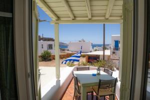 a view of a balcony with a table and chairs at Villa Ostria in Koufonisia