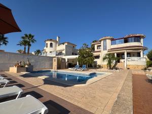 a house with a swimming pool in front of a house at Maikran Premium Fantastic Family Villa with Pool in San Fulgencio