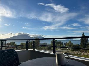 a balcony with a table and a view of a mountain at Katoria Bridge Apartment in Vlorë