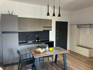 a kitchen with a table and chairs in a room at Katoria Bridge Apartment in Vlorë