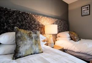 a bedroom with two beds and a headboard at Portstewart Strand in Portstewart