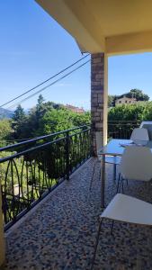 a balcony with tables and chairs and a view at Appartamento Il Salice in Carignano +22 photos