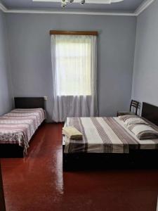 Postel nebo postele na pokoji v ubytování Joni Guest House