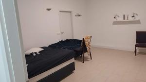 a bedroom with a bed and a chair in it at 吴民宿 in Bergisch Gladbach