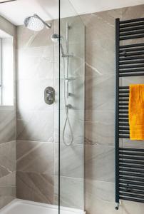 a shower with a glass door in a bathroom at Portstewart Strand in Portstewart