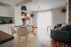 a kitchen and a living room with a table and chairs at Kromera - cisza i wygoda - komfort w rozsądnej cenie - Fair Rentals in Wrocław +7 photos
