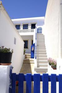 a blue fence in front of a white house at AGIAS PELAGIAS LITTLE BEACH HOUSE in Agia Pelagia Kythira