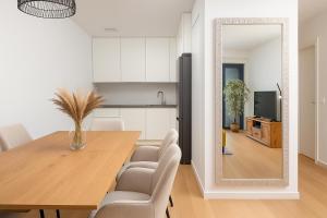 a dining room with a table and a mirror at Luxury Apartment Mona with Garden & Jacuzzi in Zadar, Borik in Zadar