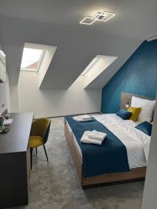 a bedroom with a bed and a desk and a window at HRADBY hotel a restaurace in Uničov