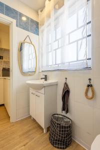 a bathroom with a sink and a mirror at Smart Studio, AC ,Fast Wi-Fi & Walk to Marina by QuickTrips in Taʼ Xbiex
