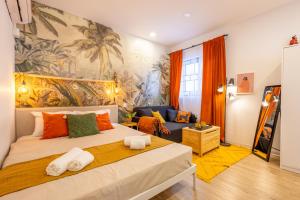 a bedroom with a large bed and a living room at Smart Studio, AC ,Fast Wi-Fi & Walk to Marina by QuickTrips in Taʼ Xbiex