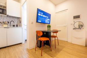 a kitchen and dining room with a table and chairs at Smart Studio, AC ,Fast Wi-Fi & Walk to Marina by QuickTrips in Taʼ Xbiex +10 photos