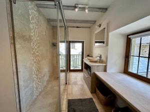 a bathroom with a shower and a sink at Maison de Saint Ours in Moye