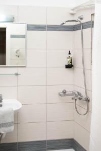 a bathroom with a shower and a sink at Konstantinos Hotel & Apartments 2 in Nydri