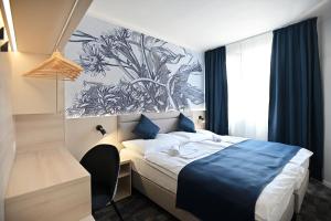 Postel nebo postele na pokoji v ubytování Hotel Merlot