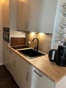 a kitchen with a sink and a counter top at Ferienwohnung Glockenberg - Westphal in Altenau