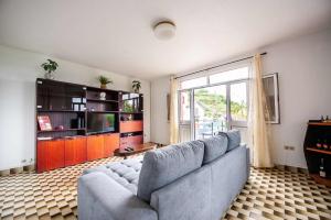 a living room with a couch and a large window at Casa reizinho in Santana