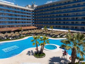 an aerial view of a hotel with a pool and palm trees at Hotel Tahití Playa & Suites 4Sup in Santa Susanna