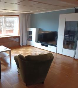 a living room with a couch and a flat screen tv at 3 Zimmer 1OG 100qm Wintergarten Dachterrasse super Badezimmer in Tangstedt