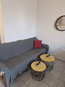 a living room with a couch and two tables at Frango Quarter 1 in Chios