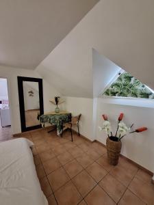 a bedroom with a bed and a table and a mirror at Appartement 2 à 6 personnes dans un magnifique complexe de Vacances à Sainte-Luce in Sainte-Luce +19 photos