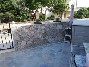 a stone retaining wall with a stone patio at SPYROS STONE house in Preveza