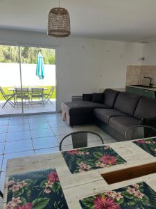 a living room with a couch and a table at Locations Ile de Ré in Sainte-Marie-de-Ré