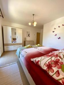 a bedroom with a large bed with a red blanket at Apartman Miljenko - Matovica in Kampor