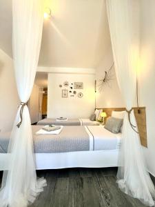 a bedroom with a large bed with curtains at Casa Mós in Lagos
