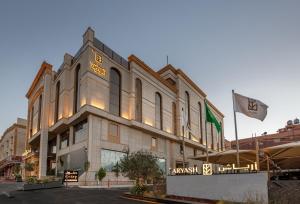 a building with a flag in front of it at Aryash Abha Hotel in Abha