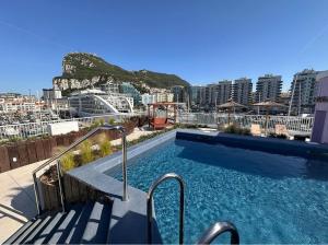 a swimming pool on the roof of a building at VV - The Marina Nest with Rooftop Pools in Gibraltar Airport
