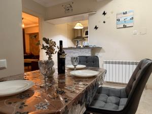 a dining room table with a bottle of wine on it at Cozy Newly Renovated Apartment in Batumi Old Town in Batumi