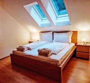 a bedroom with a bed with two towels on it at Villa Waldblick in Wagerberg
