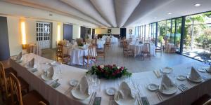 a banquet hall with white tables and chairs at Hotel Lusitano in Lobios